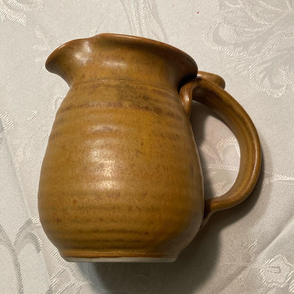 Pottery, hand thrown caramel creamer/pitcher signed, Tom Jon $29. Now $19